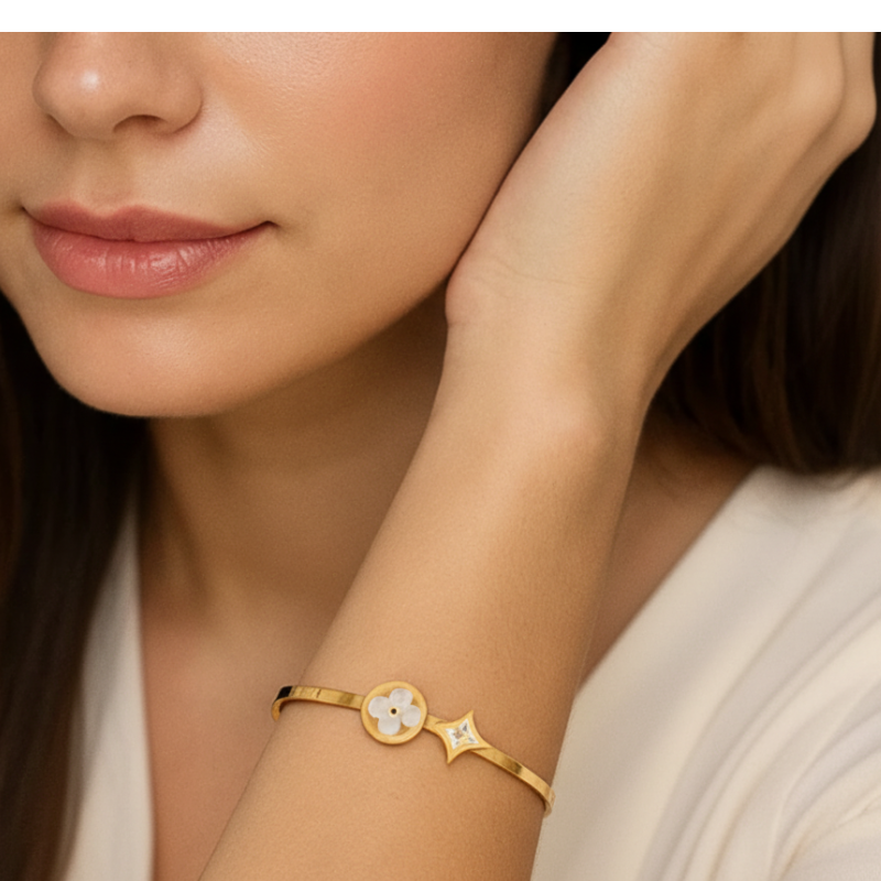 Woman wearing a gold bracelet with a white background