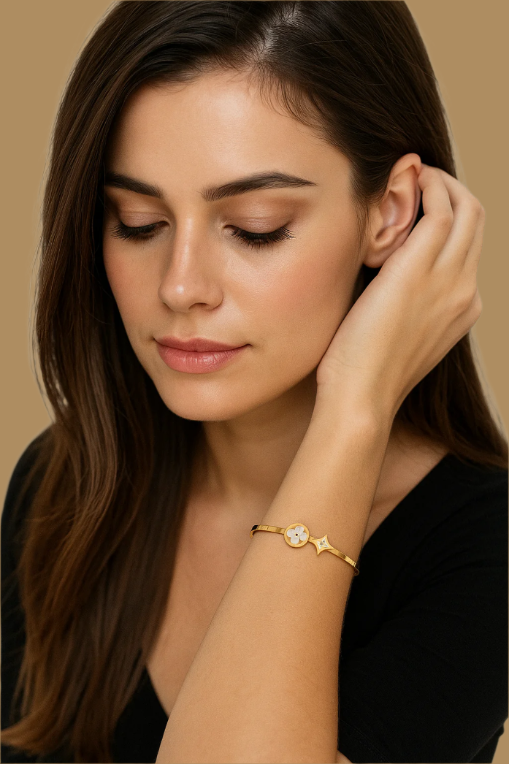Woman wearing a gold bracelet with a white background