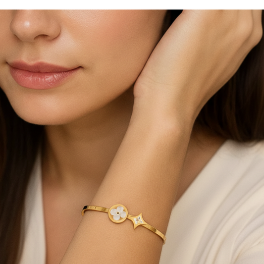 Woman wearing a gold bracelet with a white background